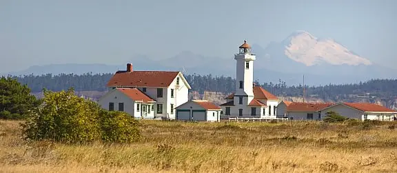 A view of Fort Worden and a mountain in the background.